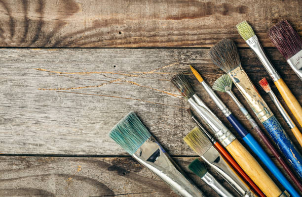 istock Paint brushes of different sizes on a wooden background, flat lay. 1458808961