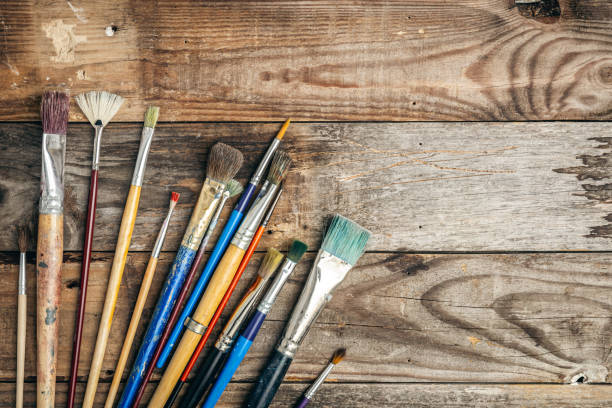 istock Paint brushes of different sizes on a wooden background, flat lay. 1458808978