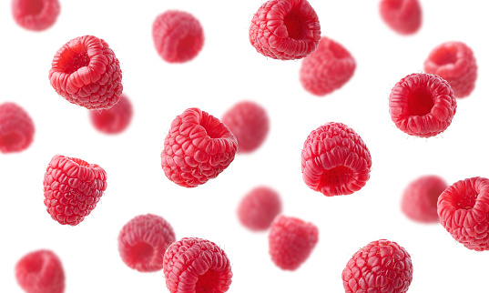 Collection of various falling fresh raspberries isolated on white background