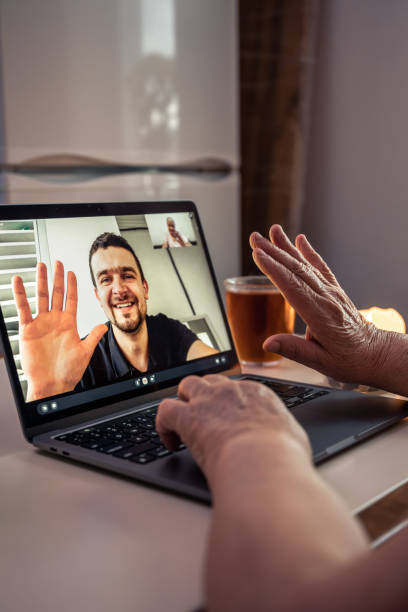 istock An old woman communicates with her son via video link through a laptop. 1458810030