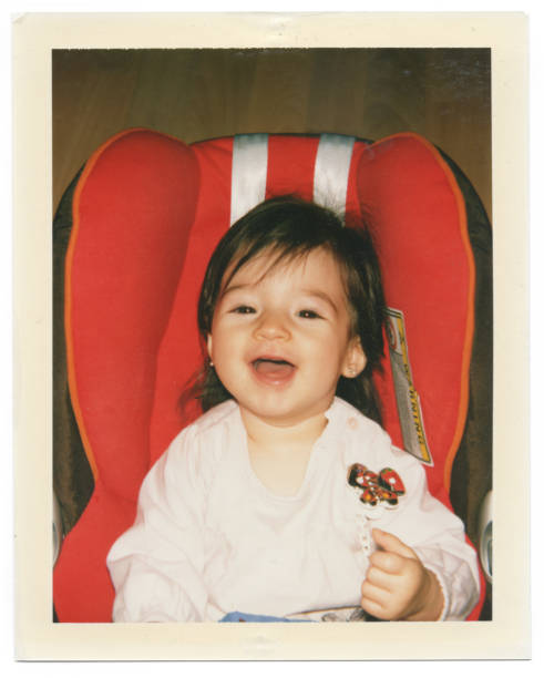 Instant photo of baby on car safety seat