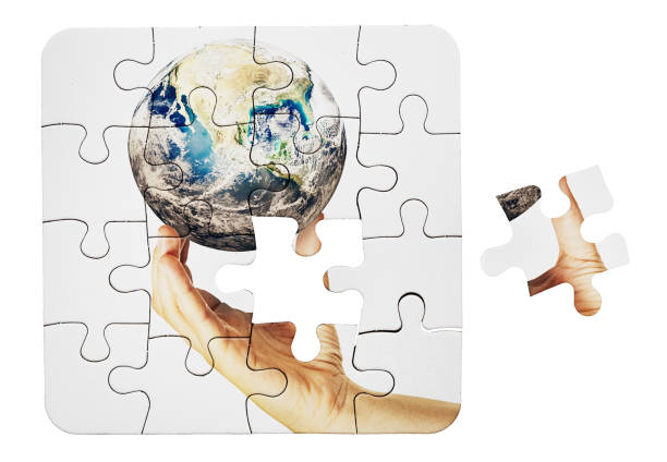 istock Jigsaw puzzle depicts caring environmentalist holding Planet Earth 1458811208