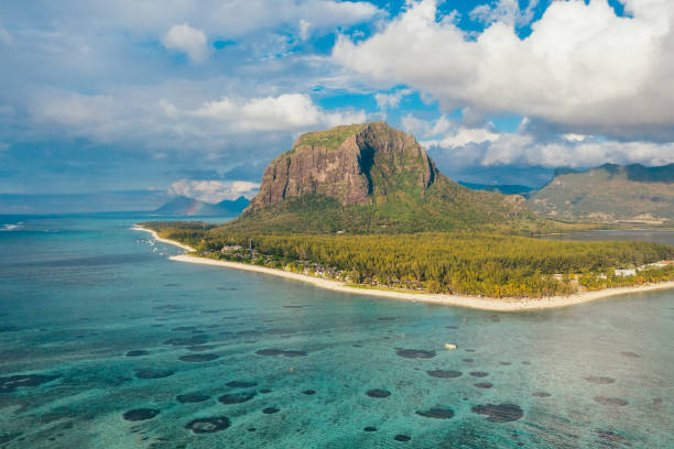 istock Turquoise lagoon protected with coral reefs on Le Morne peninsula with basalt mount on Mauritius island. Also wonderful kiteboarding and windsurfing spot. Exotic traveling aerial photo concept 1458811859
