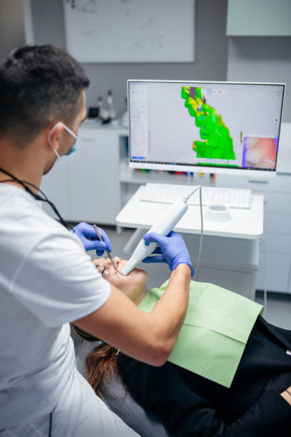 istock Dental procedure with the help of 3D tooth scanner technology. 1458817503