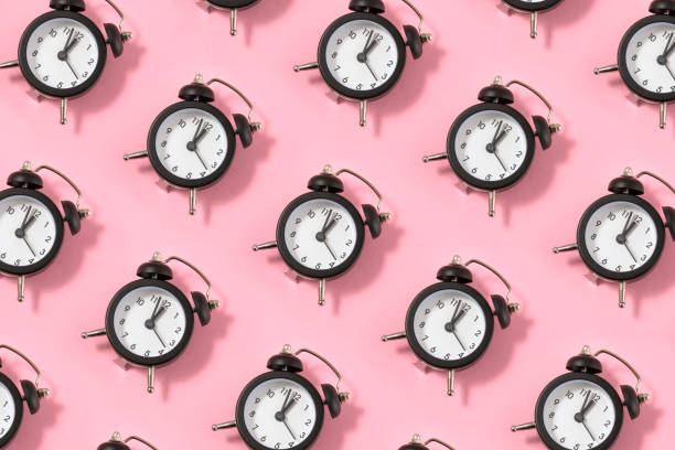 istock Alarm Clock on Pink Background 1458817977