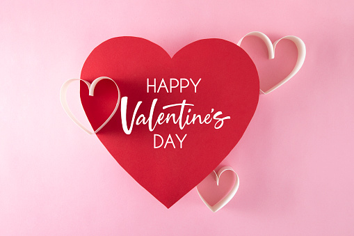 Heart shaped red paper with Valentine’s day message and copy space