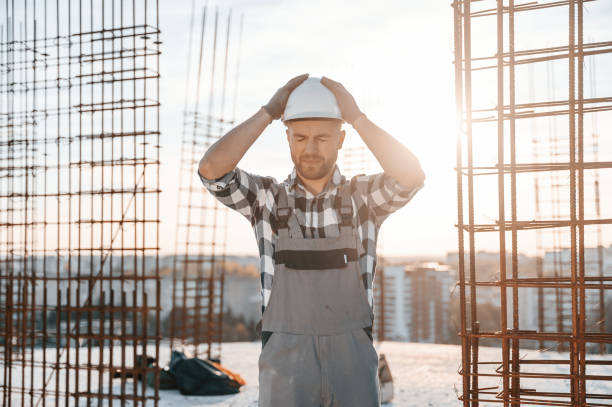 istock Standing in a beautiful sunlight. Man is working on the construction site at daytime 1458818591