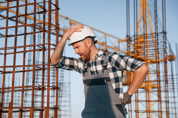 istock Feeling bad. Having headache. Man is working on the construction site at daytime 1458818766