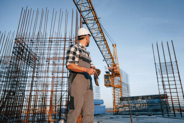 istock Wearing the gloves. Man is working on the construction site at daytime 1458818822