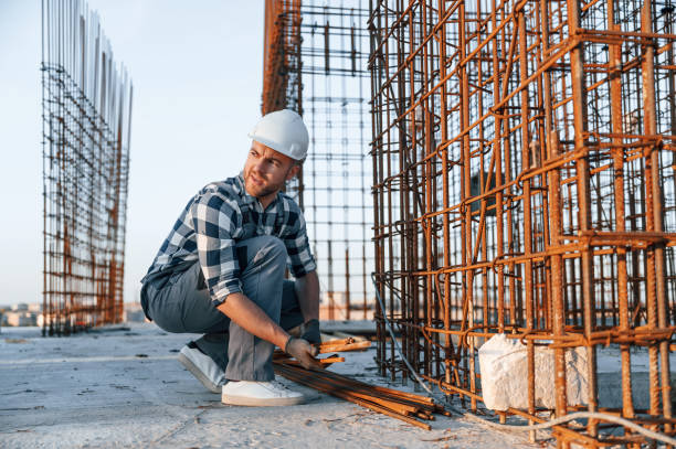 istock With rusty metal objects. Man is working on the construction site at daytime 1458818865