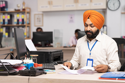 Indian Sikh businessman working at office