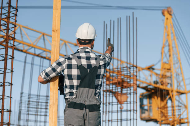 istock Giving orders to crane operator. Man is working on the construction site at daytime 1458820576