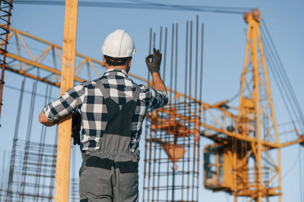 istock Giving orders to crane operator. Man is working on the construction site at daytime 1458820585