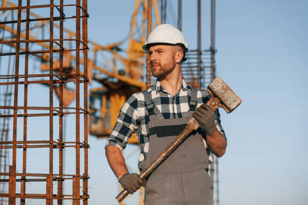 istock With big hammer in hands. Man is working on the construction site at daytime 1458820851