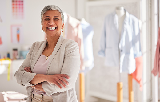 Happy woman, fashion design manager and portrait, arms crossed and creative startup. Mature seamstress, entrepreneur and small business owner, workshop leader and manufacturing in production studio