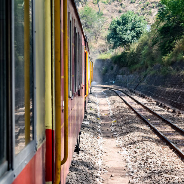istock Toy Train moving on mountain slopes, beautiful view, one side mountain, one side valley moving on railway to the hill, among green natural forest. Toy train from Kalka to Shimla in India, Indian Train 1458825477