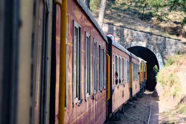 istock Toy Train moving on mountain slopes, beautiful view, one side mountain, one side valley moving on railway to the hill, among green natural forest. Toy train from Kalka to Shimla in India, Indian Train 1458825512