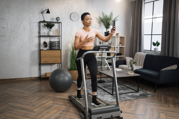 istock Healthy young sports woman using phone having video conference while working out 1458825764