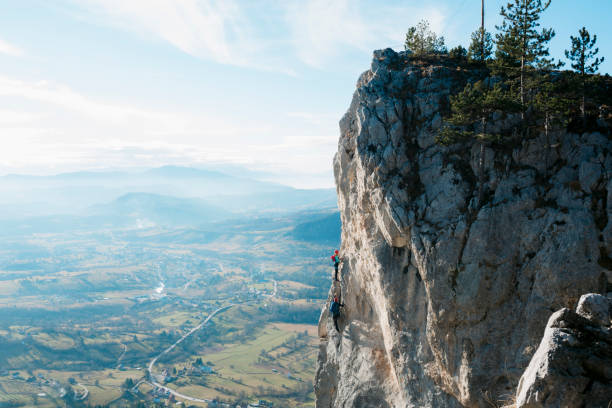 istock Two mountaineers rock climbing a steep mountain 1458828552