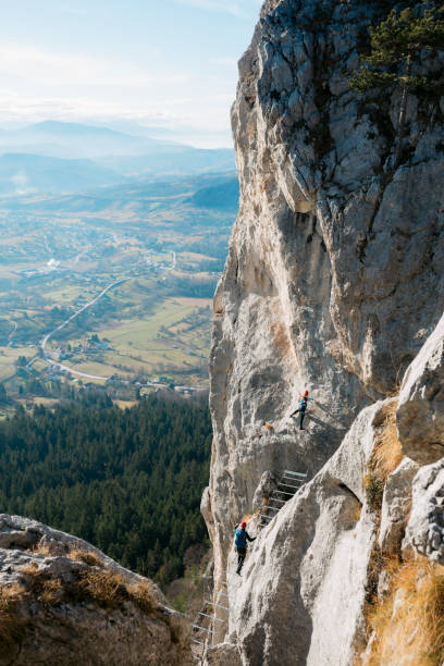 istock Two climbers climbing on the rock mountain on a sunny day 1458828610