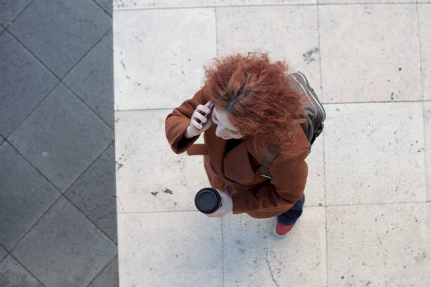 Woman seen from above talking on cell phone