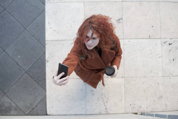 istock Woman seen from above taking a selfie 1458833447