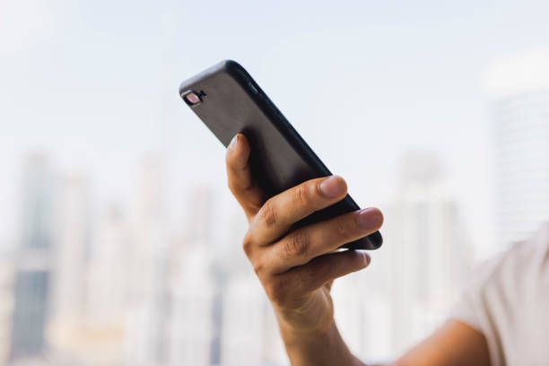 istock Close-up of man holding cellphone with one hand 1458834507