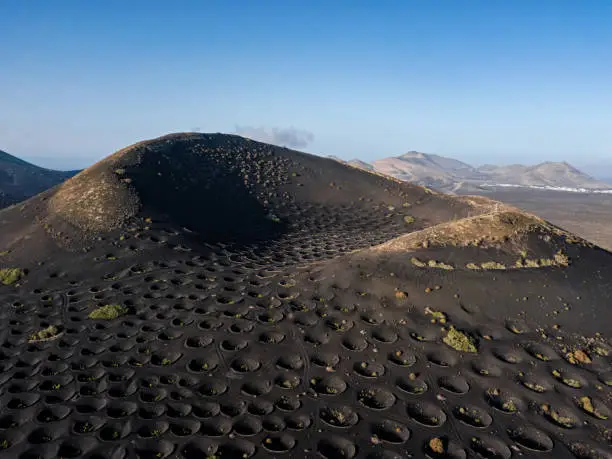 Photo of Aerial view of crater in Wine valley of La Geria, Lanzarote, Canary islands, Spain.