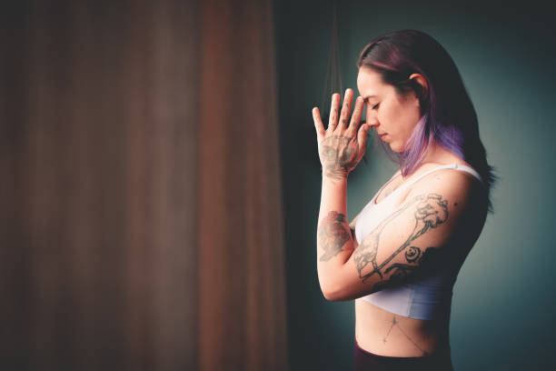 istock woman with hands positioned in Namaste 1458835807