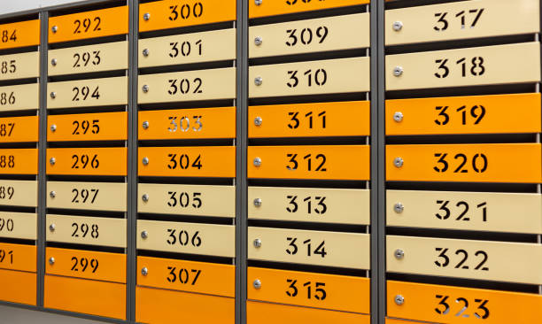 istock Mailboxes for letters and correspondence. Modern multicolored mailboxes with numbers in the lobby of a residential or office building close-up. 1458835926