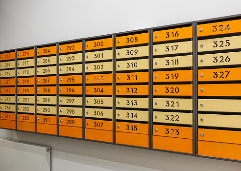 Mailboxes for letters and correspondence. Modern multicolored mailboxes with numbers in the lobby of a residential or office building close-up.