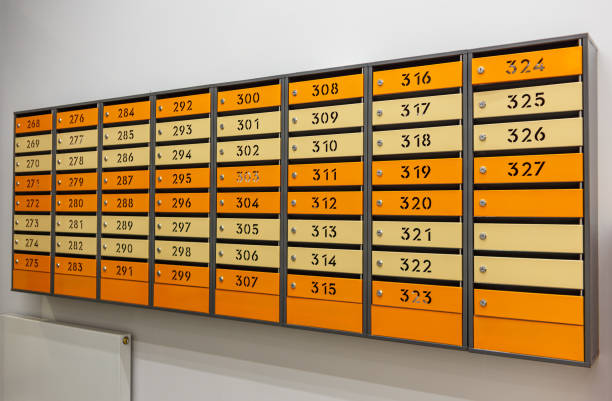 istock Mailboxes for letters and correspondence. Modern multicolored mailboxes with numbers in the lobby of a residential or office building close-up. 1458835939