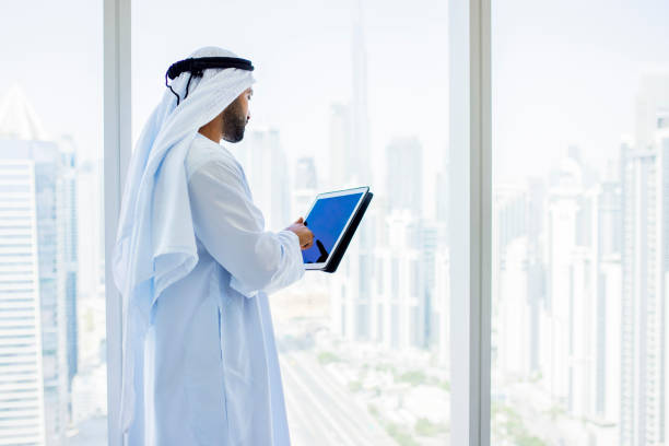 istock Side view of Arab businessman using digital tablet in modern office 1458836114