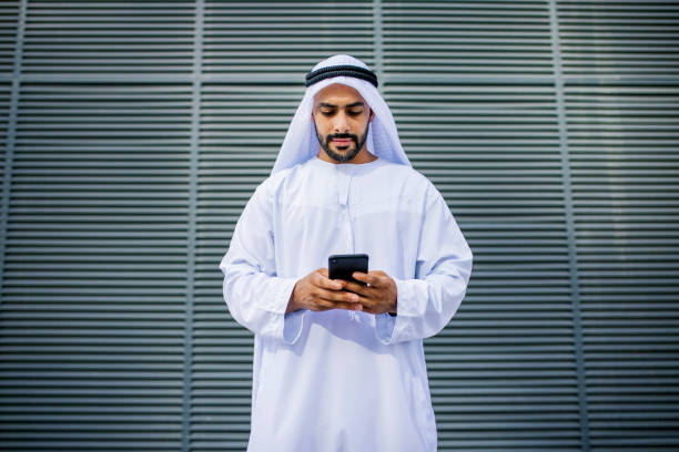 istock Portrait of bearded Arab businessman using cellphone 1458836269