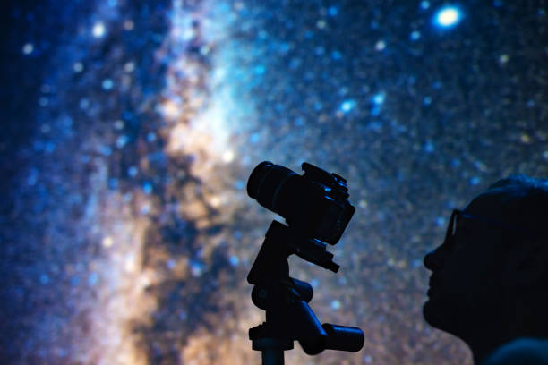 istock Astronomer photographing Milky Way night sky with a camera. 1458836803
