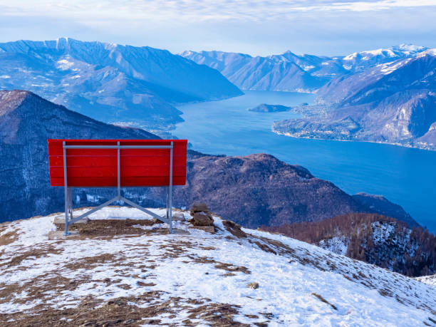Big red bench on the landscape of Lake Como