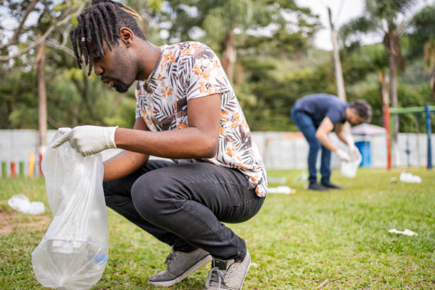 istock Two community volunteers picking up trash in a public park 1458843779