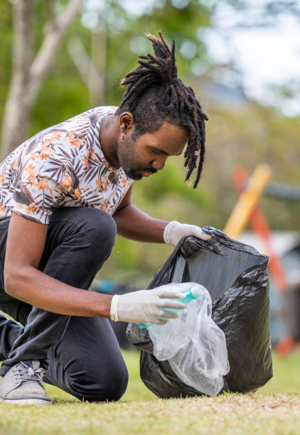 istock Man collecting trash in a playground during a community clean-up project 1458843870