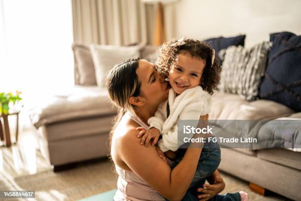 Portrait Of Toddler Girl Having Fun With Her Mother In The Living Room At Home Stock Photo - Download Image Now