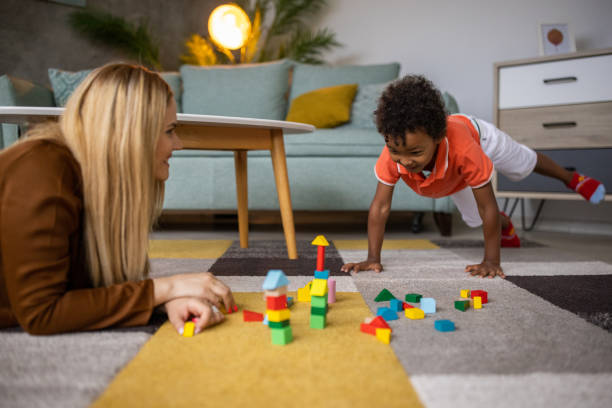 istock Mom and son playing at home 1458847425