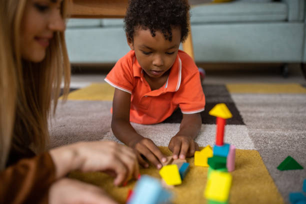 istock Mom and son playing at home 1458847513