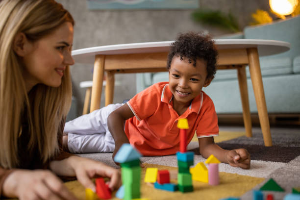 istock Mom and son playing at home 1458847556