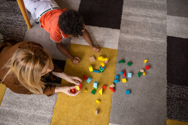 istock Mom and son playing at home 1458847775