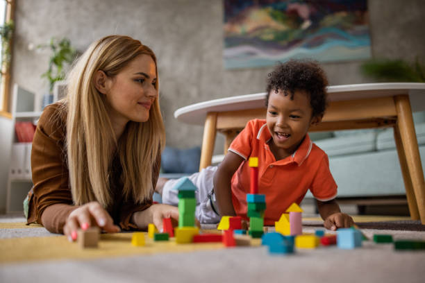 istock Mom and son playing at home 1458847873