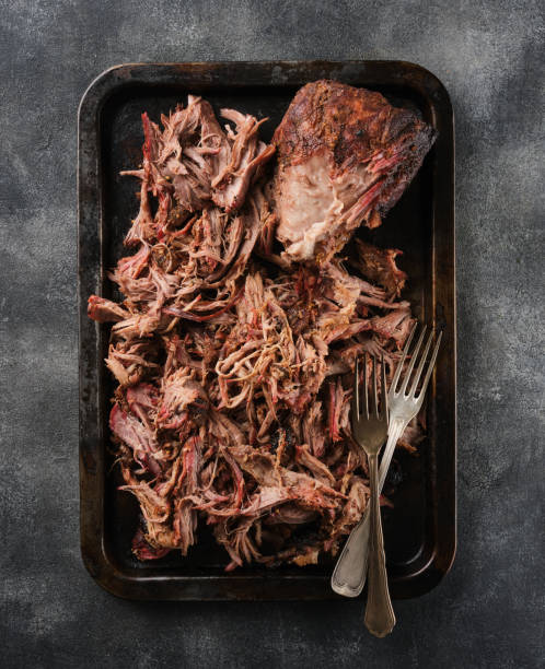 istock Traditional barbecue pulled pork. Slow cooked pulled pork shoulder. Juicy pork meat cooked in a smoker by low and slow 1458848022