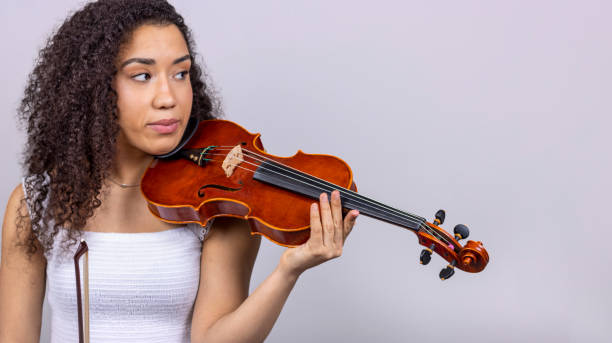 istock Classical music concept. Copyspace. Disappointed young girl with her violin on her shoulder. 1458849465