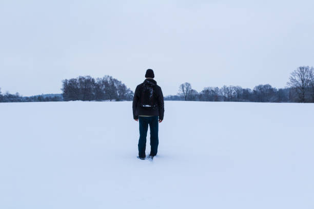 istock Man with backpack walking in winter Czech landscape 1458849783