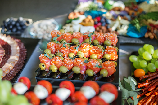 catering buffet table with different appetizers. Italian and french dishes.
