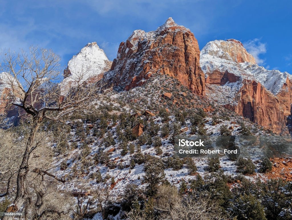 View of Bridge Mountain and the Sentinel Peak after snowfall near the Human History Museum in Zion National Park Utah in winter Bridge Mountain Stock Photo