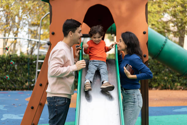 istock Family playing with their son on the slide 1458851656